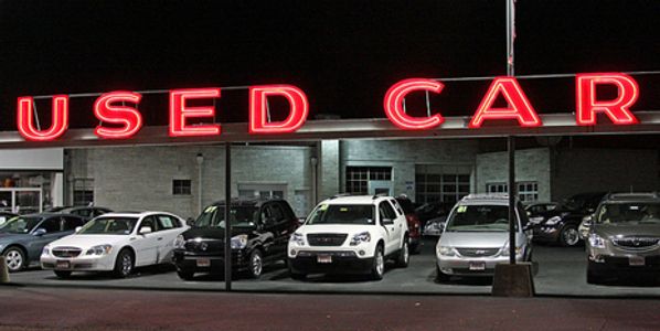 Used cars under an awning.