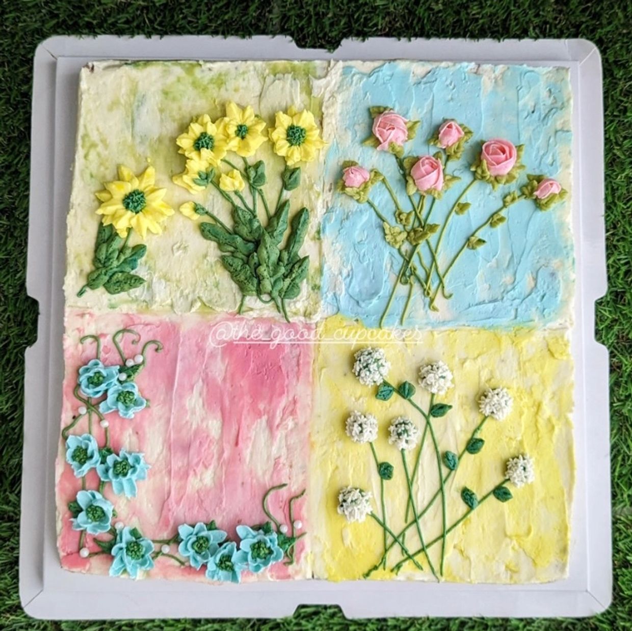 Square cake decorated with four different floral designs on colorful backgrounds.