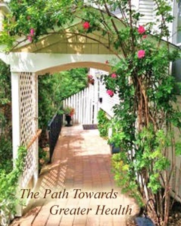 A garden path with an archway and blooming flowers.