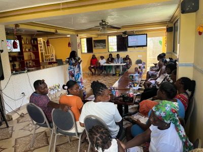 Group meeting in a room with people seated around a table.