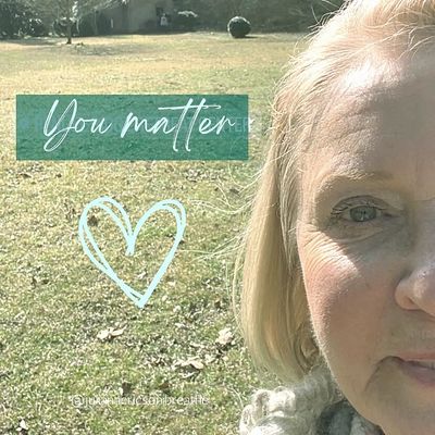 close up of woman with words "you matter" and a heart drawn
