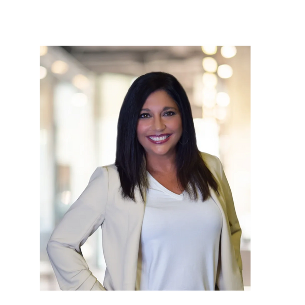 Confident woman smiling in a professional setting.