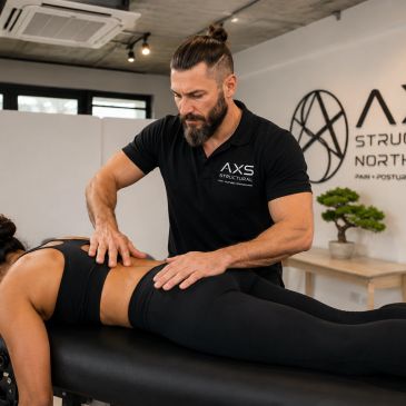 Physiotherapist treating a patient's lower back.