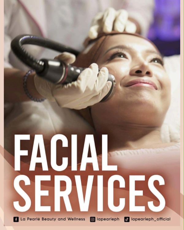 Woman receiving facial treatment with a device.