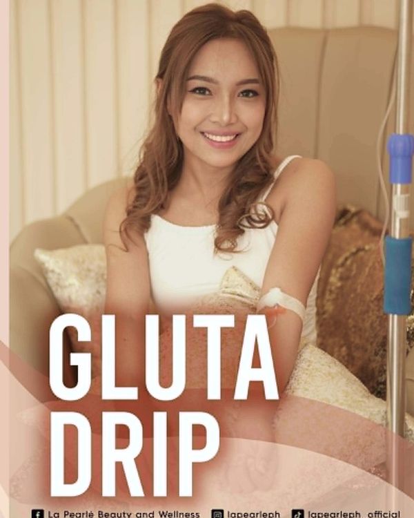 Woman smiling with an IV drip.