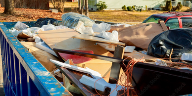 Dumpster filled with garbage for junk removal service. 