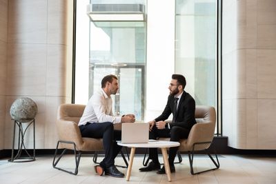 Two men in a modern office having a serious conversation.