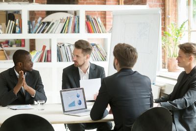 Four men having a business meeting in an office.