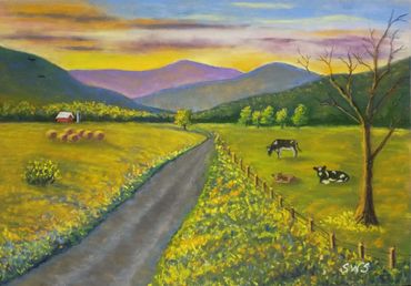 Peaceful countryside with cows and a sunset.