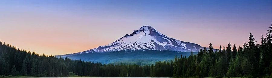 Mount Hood in Oregon landscape, it's sunrise, so the sky is inks and purples with 