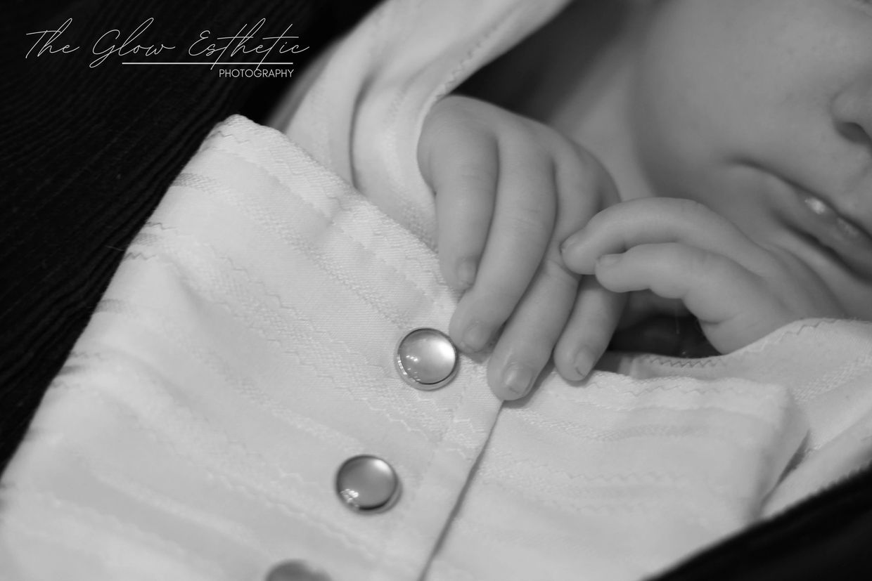 Black and white newborn holding shirt. Missoula, Montana photographer. 