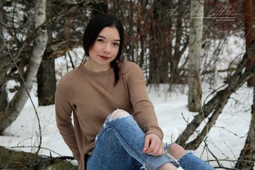 Senior photo, girl outside in snow sitting in trees. Missoula, Montana photographer. 
