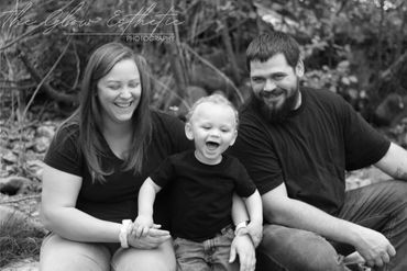 Black and white, family laughing by river in summer. Missoula, Montana photographer. 