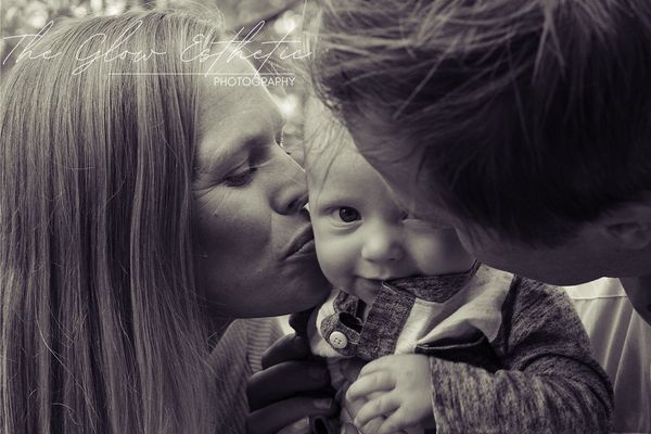 Black and white family photo kissing baby. Baby looking at camera. Missoula, Montana photographer. 