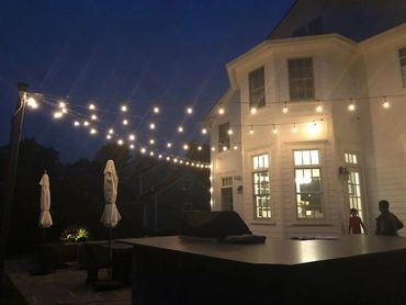 people outside a house with lights 