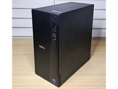 Black Dell desktop computer tower on wooden surface.
