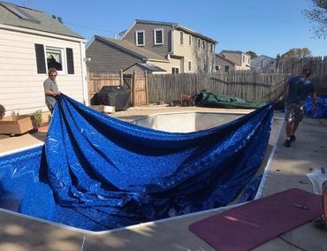two men installing In Ground Pool Liners