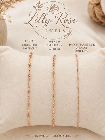 Three delicate pink and gold chain samples displayed on a cushion.