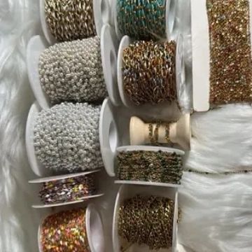 Spools of decorative chains and beads in various colors and textures.