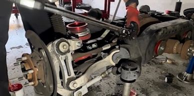 Close-up of a car's rear suspension assembly.