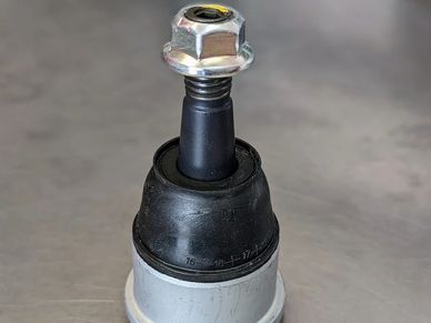 Close-up of a mechanical part with a bolt and rubber.