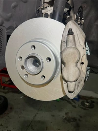 Close-up of a car brake rotor and caliper.
