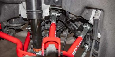 Close-up of red automotive suspension components.