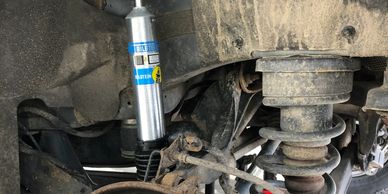 New shock absorber installed on vehicle's suspension system.