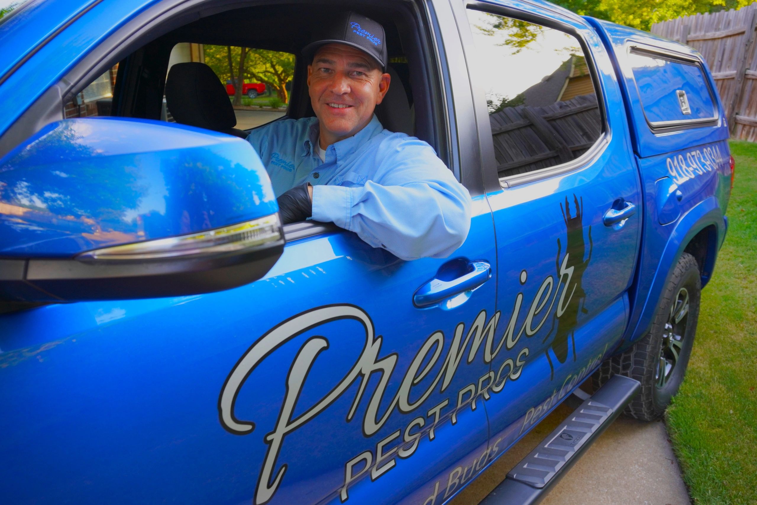 Premier Pest Pros owner in company truck ready to provide pest control services.