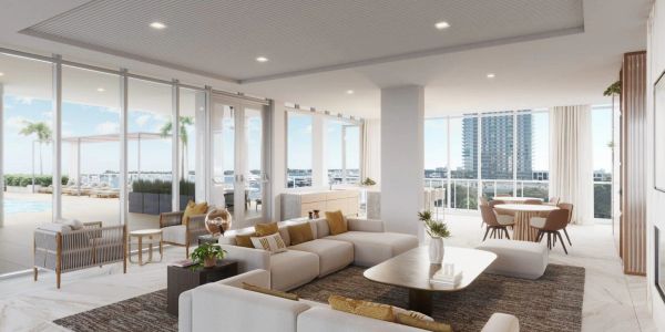 Modern living room with large windows and ocean view.