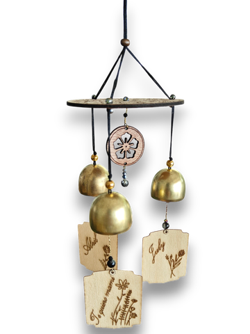 Decorative wind chime with wooden and metal elements showing months and floral designs.