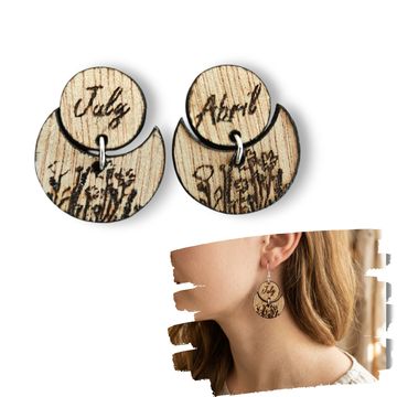 Wooden earrings engraved with months and floral designs.