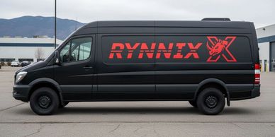 Black delivery van with bold red RYNNIX logo and rhino emblem parked outdoors.