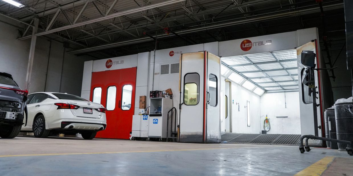 Car repair and painting booth inside an auto shop.