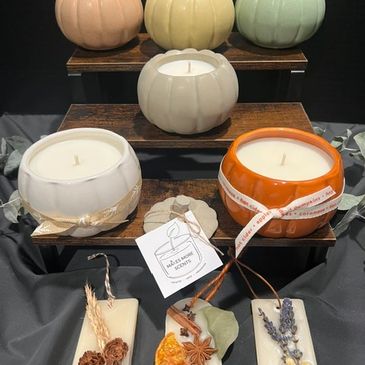 Decorative pumpkin-shaped candles and scented wax tablets.