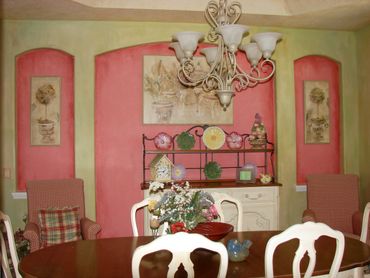 A beautiful pink color painting on the wall of a kitchen
