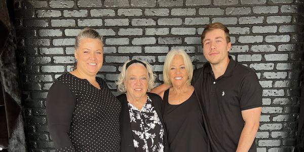 A group of artists smiling and posing for the camera