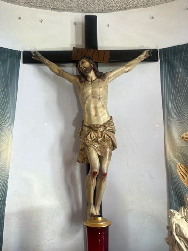 Statue of Jesus Christ crucified on the cross inside a church.