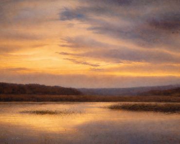 Sunset over a calm lake with soft clouds.