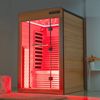 Modern infrared sauna emitting red light.