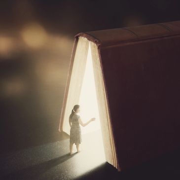 An upside-down open book with bright light emerging from the interior. A woman is peeking inside.
