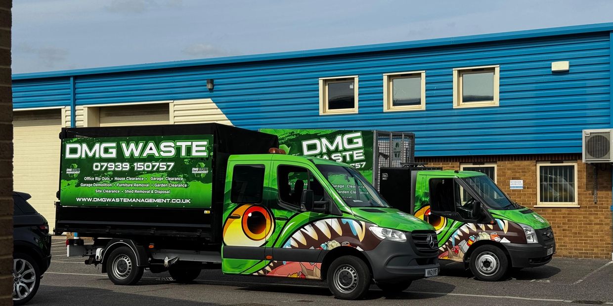 A photo of both of the DMG Waste Management vans, side by side. In poole.