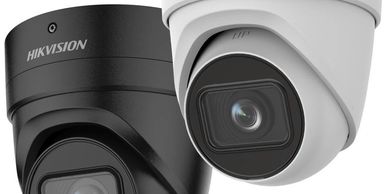 Two Hikvision security cameras, one black and one white.