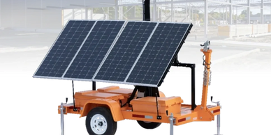Portable solar panel trailer with adjustable panels and wheels.