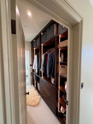 Bespoke dark oak dressing room cabinetry  made in our Hampshire joinery workshop