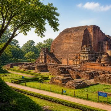 Ancient brick ruins with staircases surrounded by greenery.
