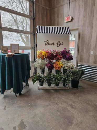 Flower bar with colorful flowers on display indoors.