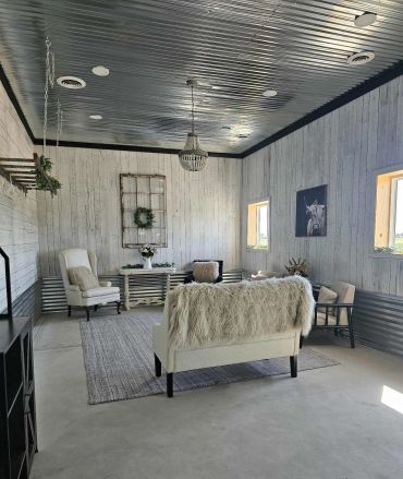 Modern rustic living room with white furniture and decor.