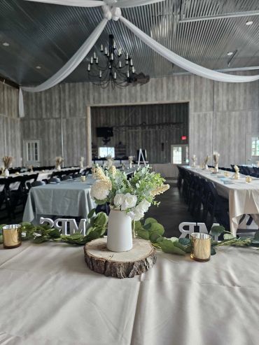 Rustic wedding tables with floral centerpieces.