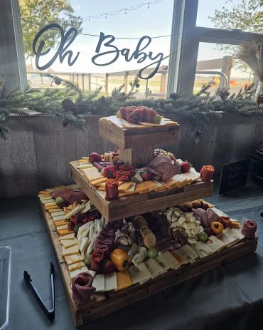 Three-tiered charcuterie board at a baby shower.